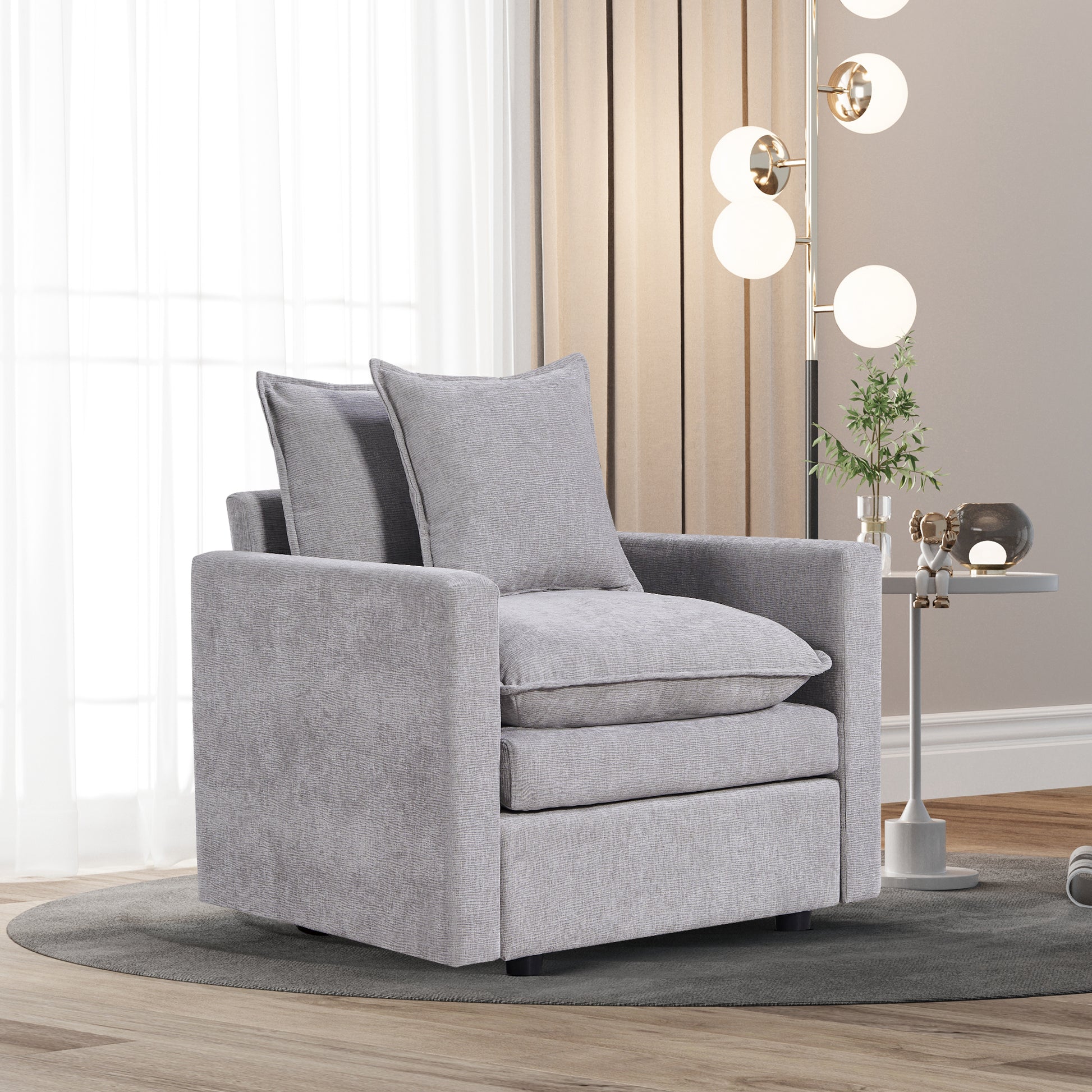 Plush grey fabric armchair with deep seat cushions and back pillows