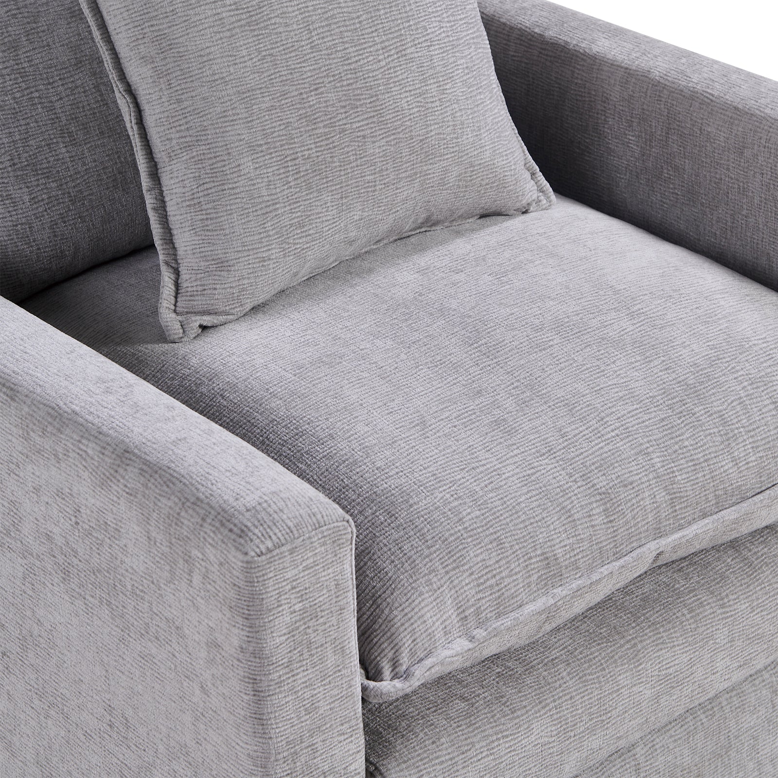 Closeup of a textured light gray fabric armchair cushion with a matching throw pillow