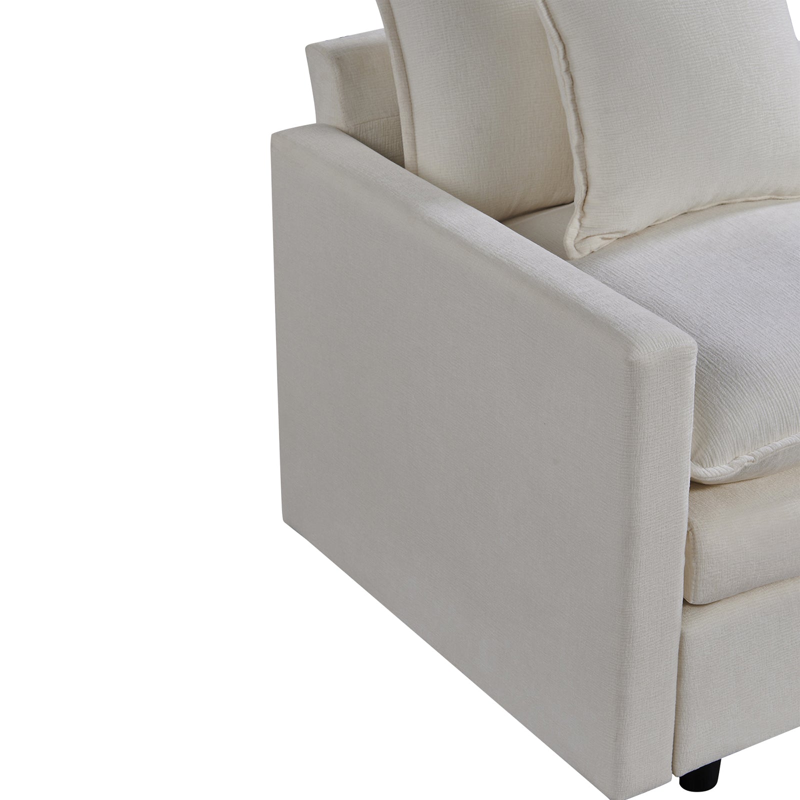 Closeup of a textured cream fabric armchair with plush cushions