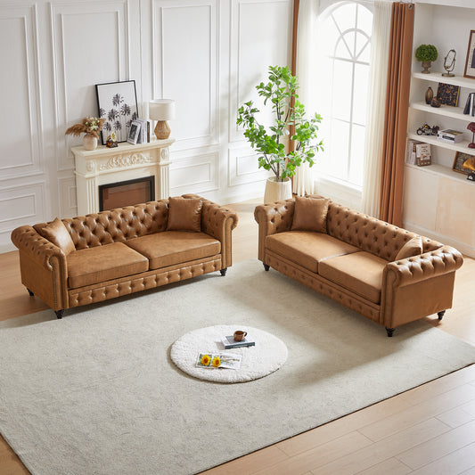Brown leather chesterfield sofa with button tufting and nailhead trim detail