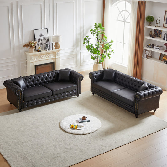 Dark brown faux leather chesterfield sofa with tufted back and nailhead trim