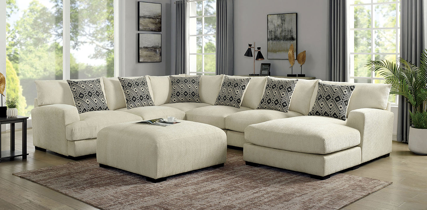 Cream boucle fabric sectional sofa with geometric accent pillows and matching ottoman for comfortable living room seating