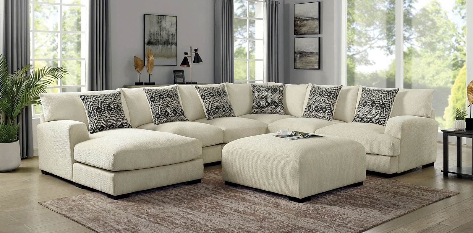Cream sectional sofa with decorative geometric throw pillows and matching ottoman