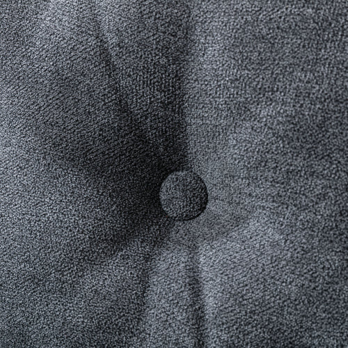 Closeup of tufted dark gray velvet fabric with a single button detail