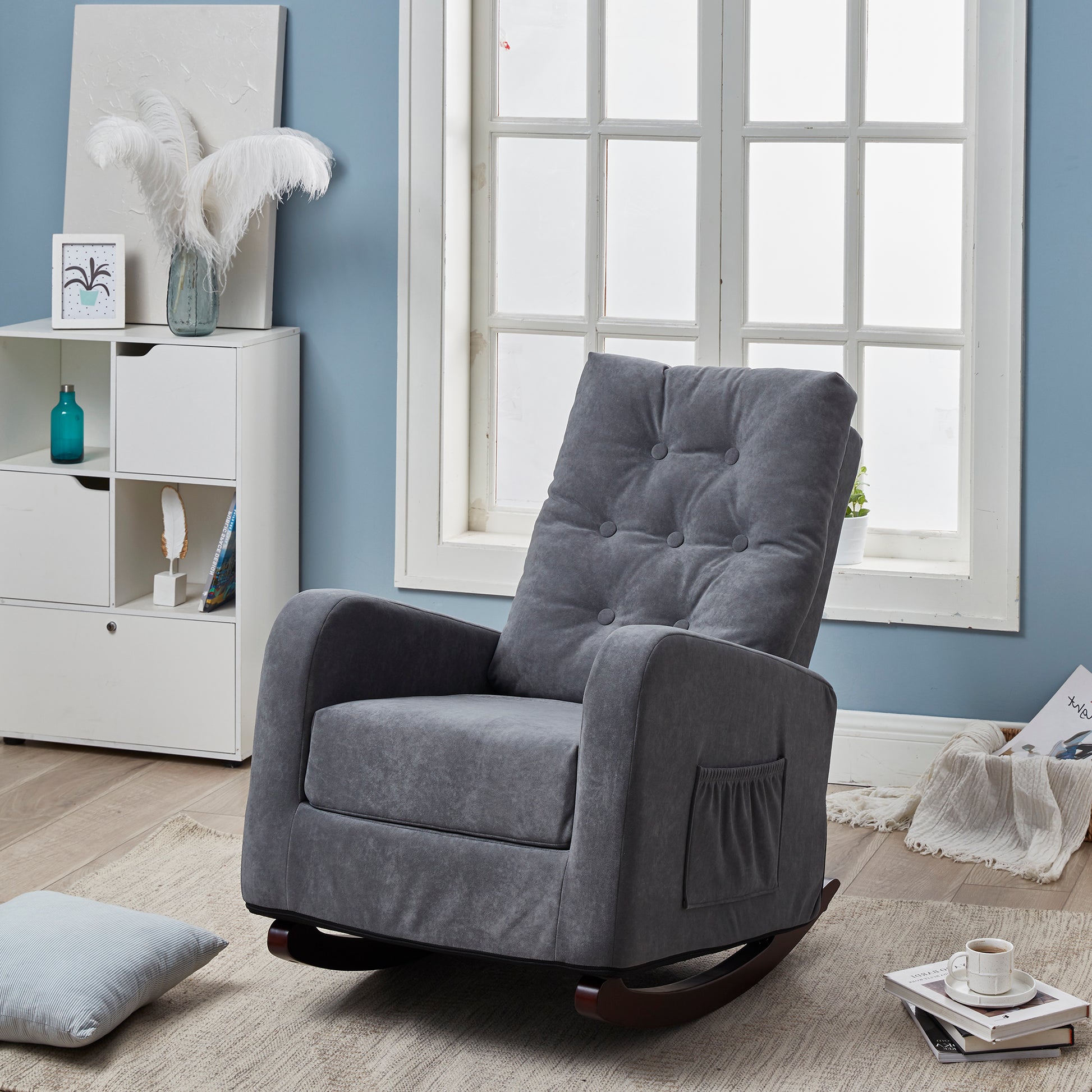 Grey upholstered rocking chair with tufted back and side pocket