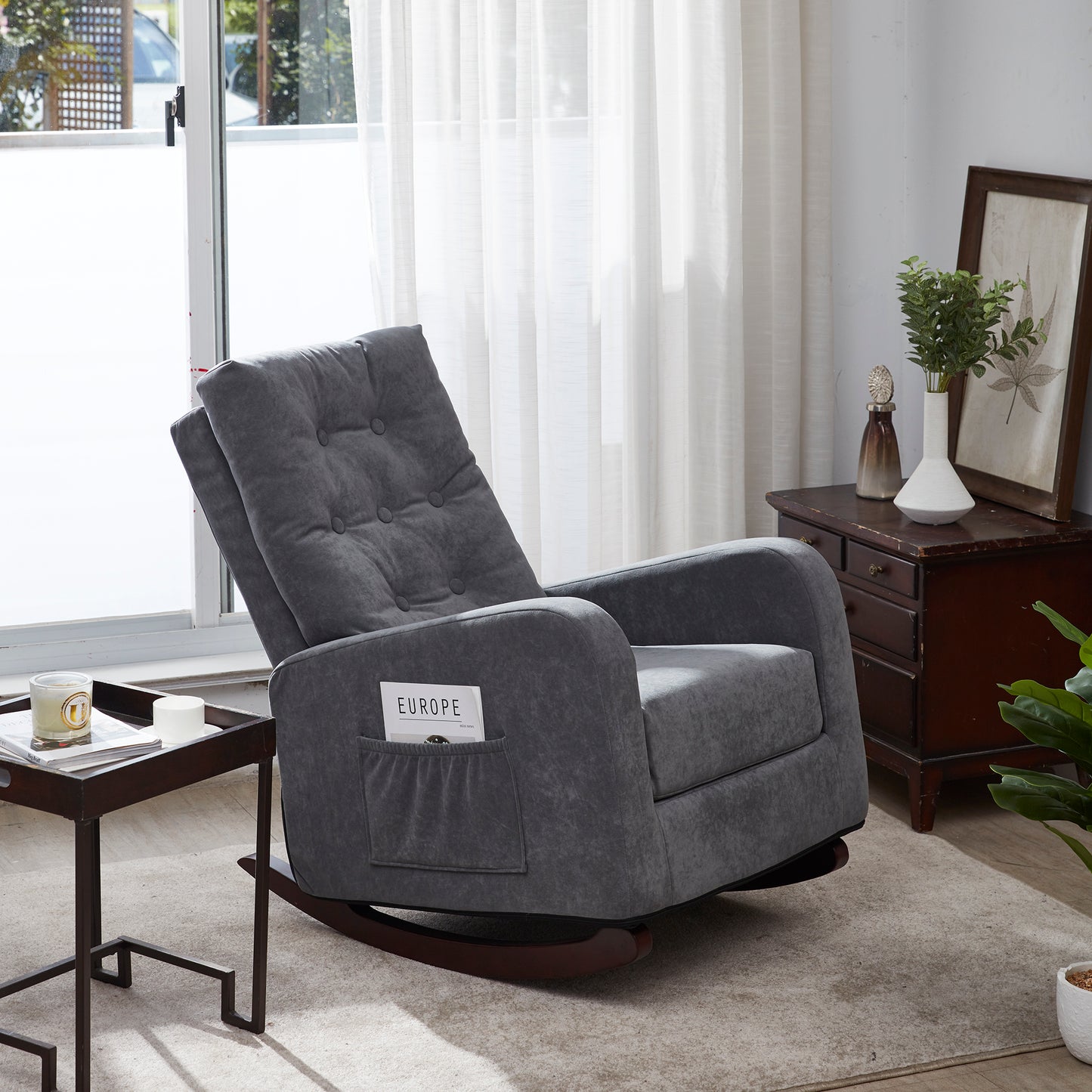 Gray upholstered rocking chair with tufted back and side pocket