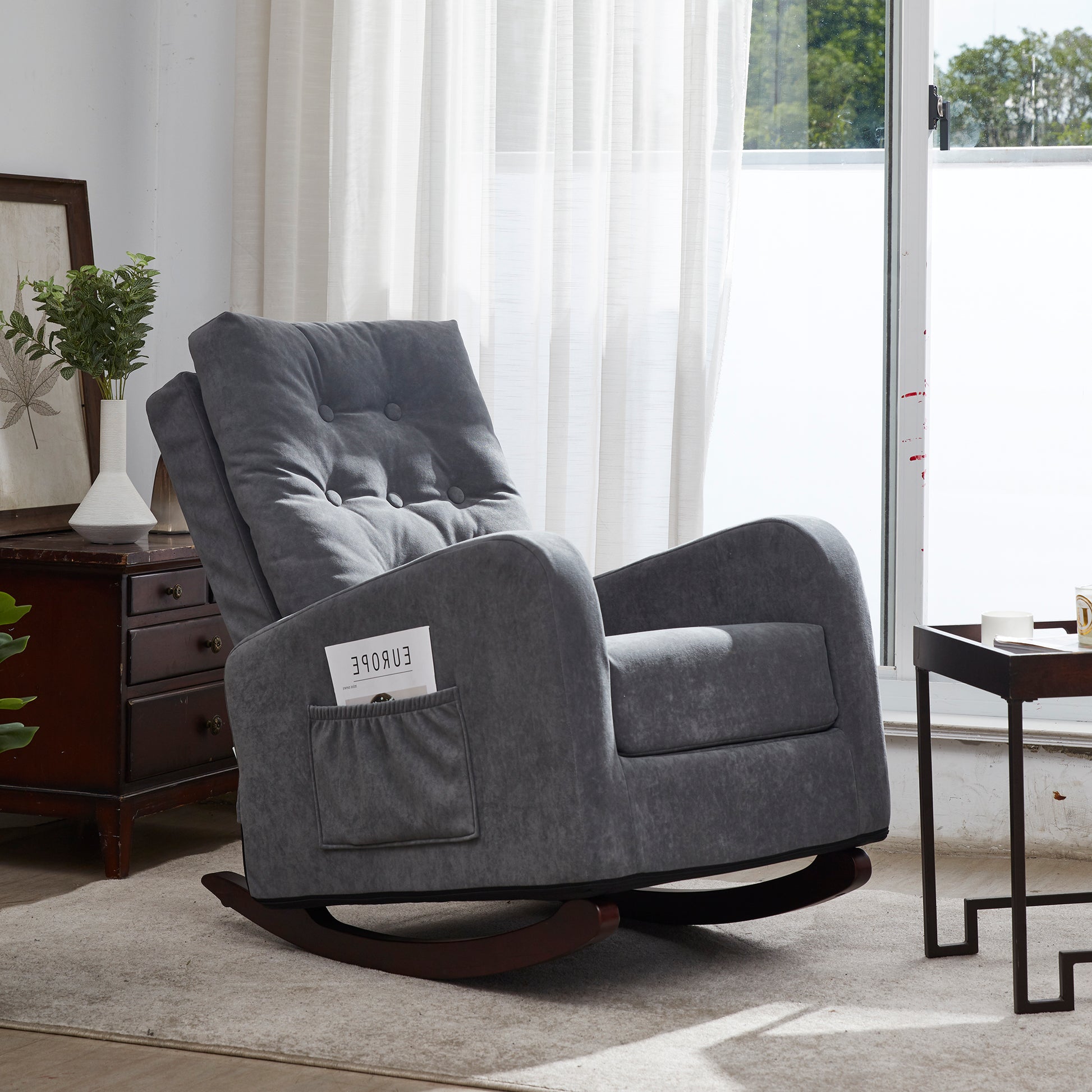 Plush grey fabric upholstered rocking chair with tufted back and side pocket