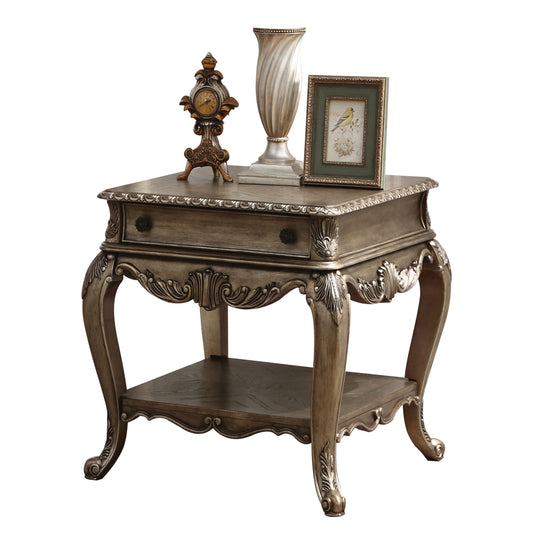 Antiquestyle wooden side table with ornate carvings and a single drawer