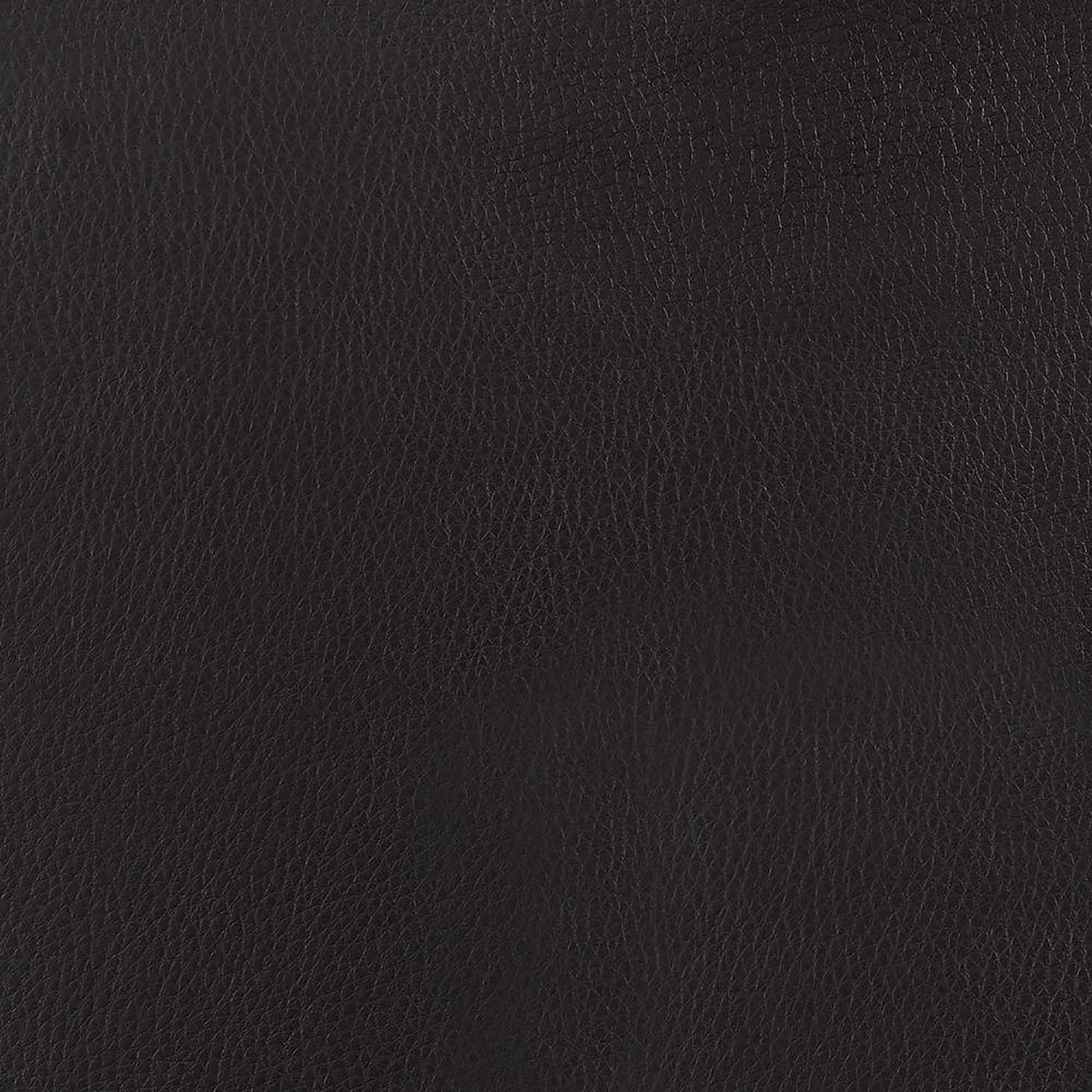 Closeup texture of black vegan leather showcasing subtle grain patterns