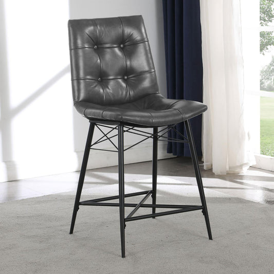 Gray tufted faux leather bar stool with black metal legs a stylish addition to any kitchen counter