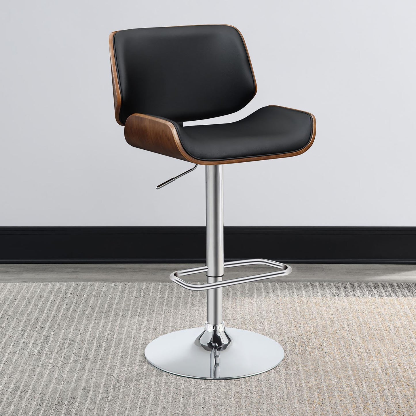 Black leather bar stool with curved walnut wood back and chrome base