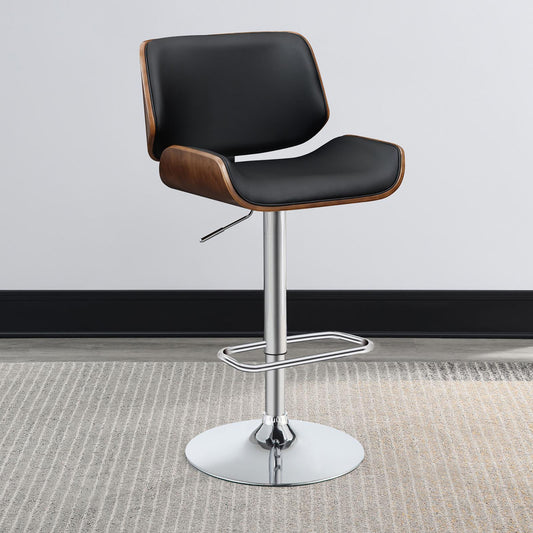 Black leather bar stool with curved walnut wood back and chrome base