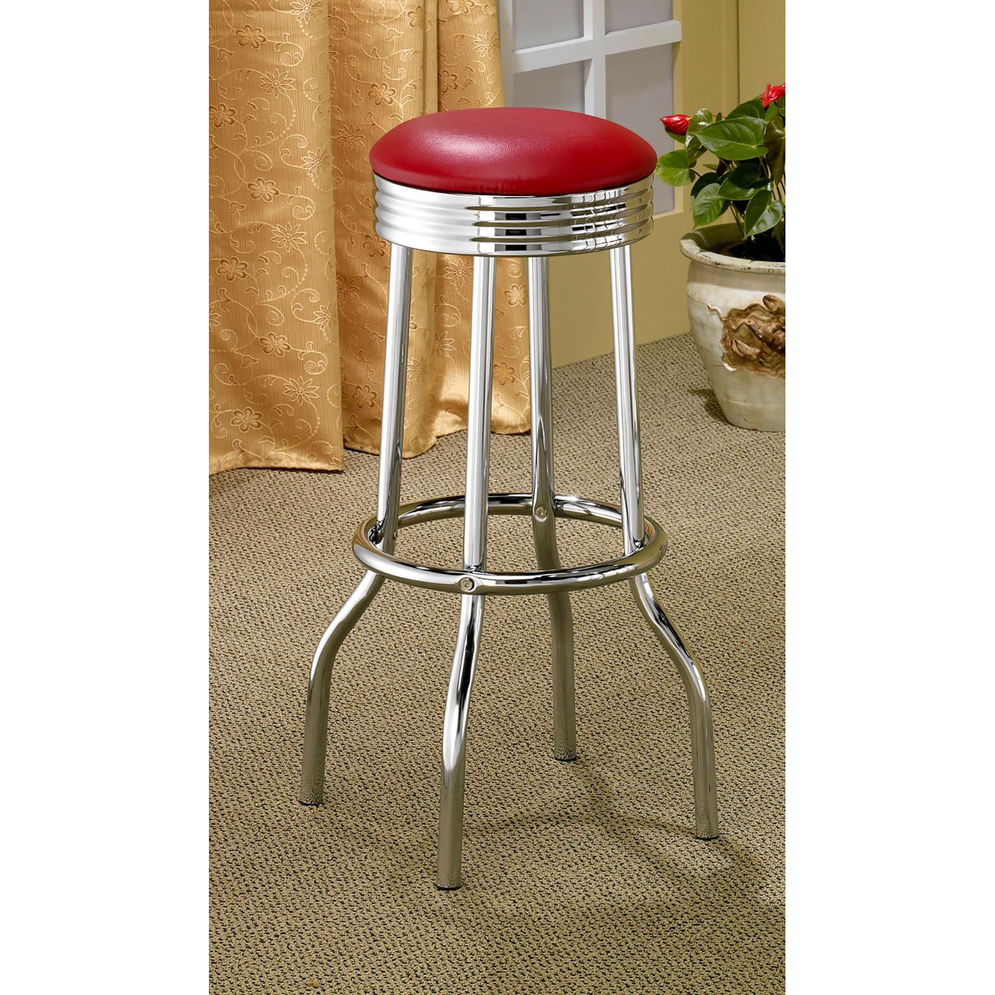Red vinyl diner bar stool with chrome base and footrest