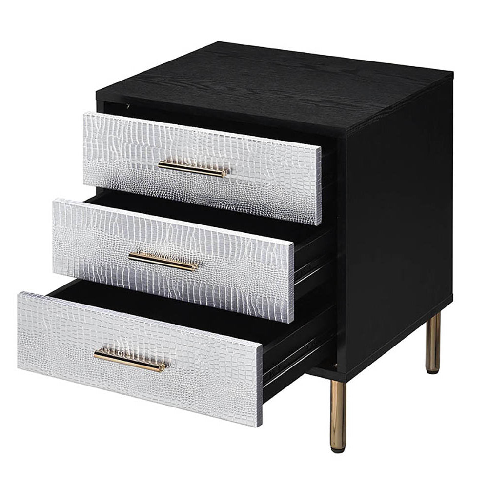 Black end table with three textured silver drawers and gold handles