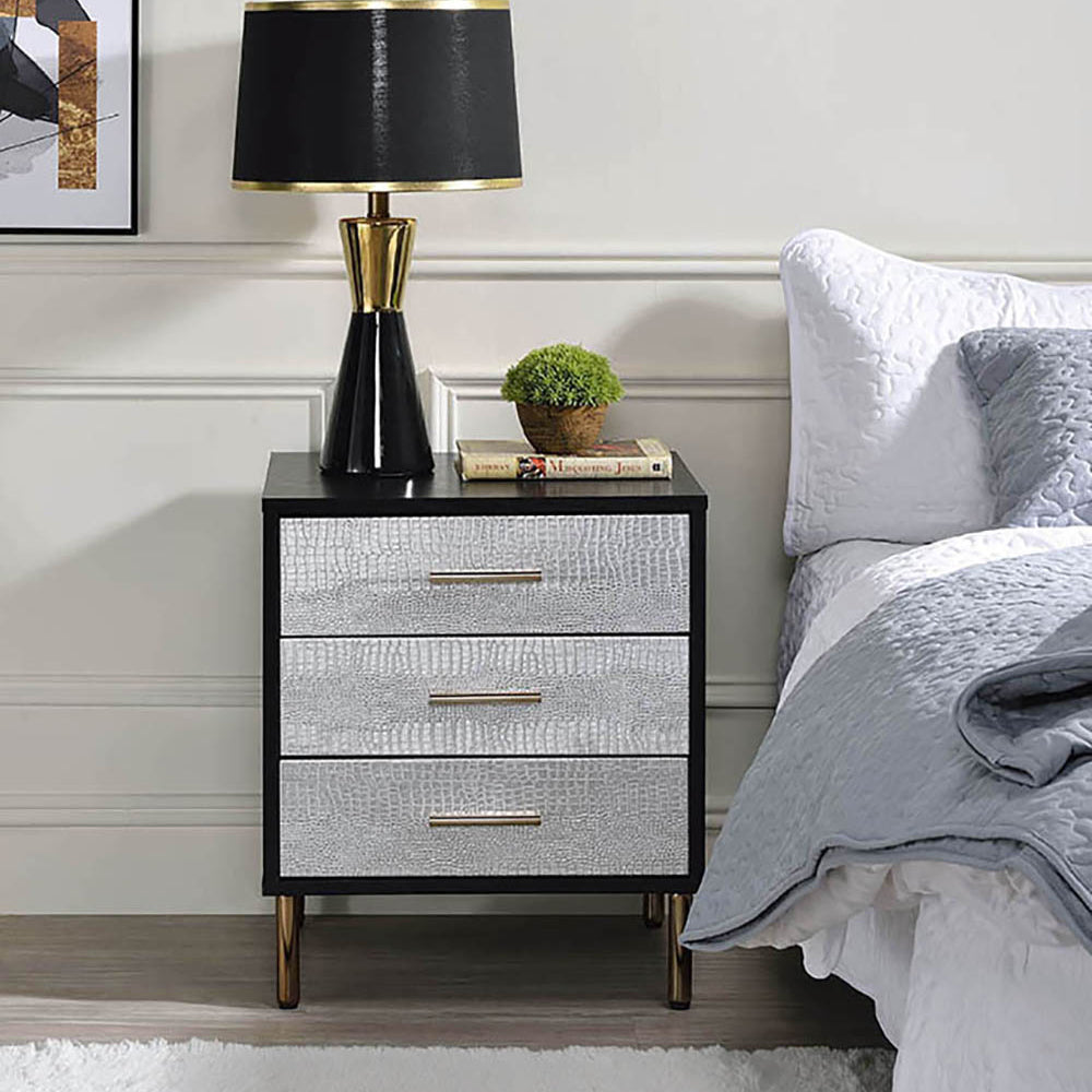 Sleek black nightstand with three silver crocodiletextured drawers and gold handles