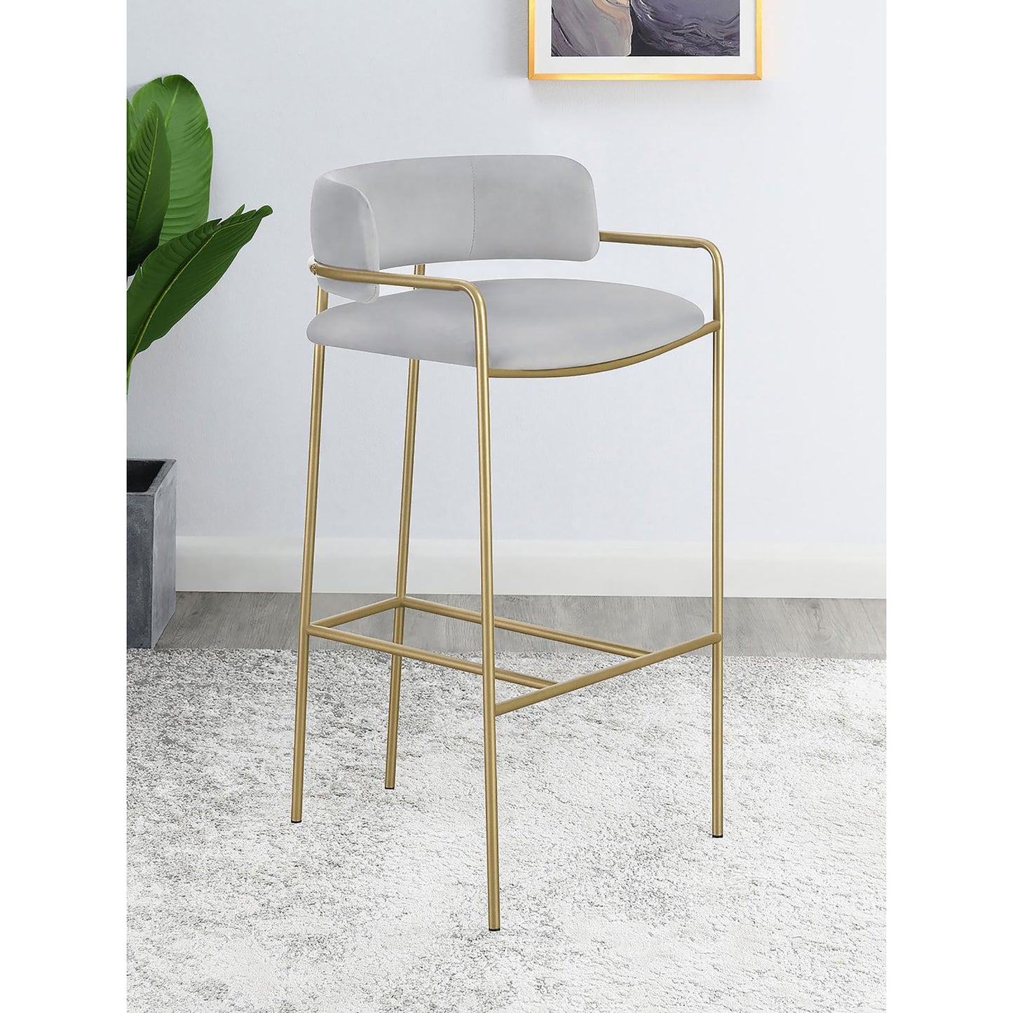 Modern grey velvet bar stool with gold metal legs and armrests