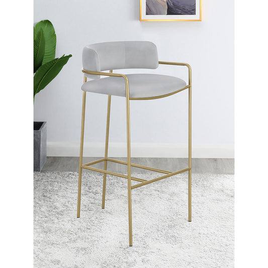 Modern grey velvet bar stool with gold metal legs and armrests