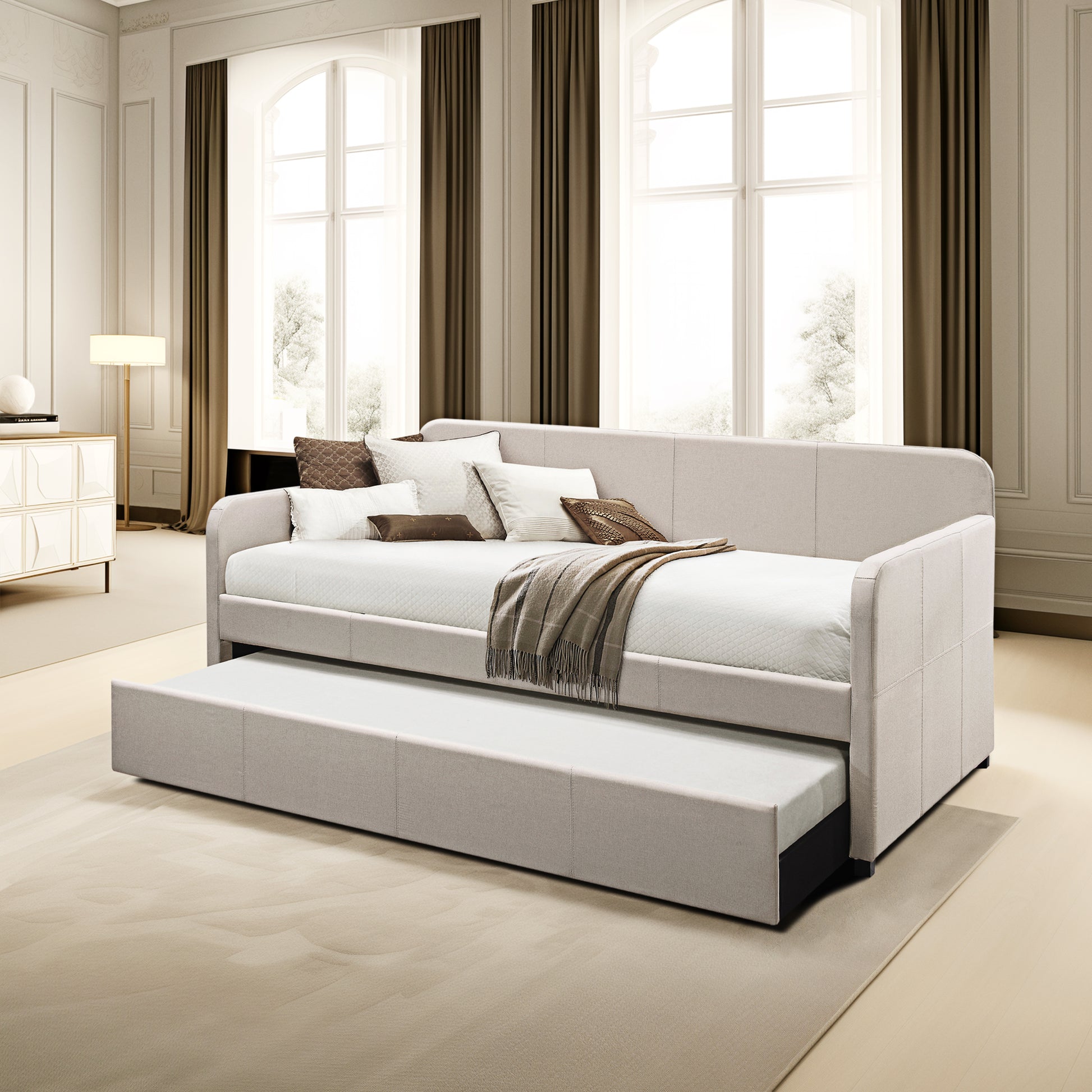 Light beige upholstered daybed with a pullout trundle perfect for guest rooms