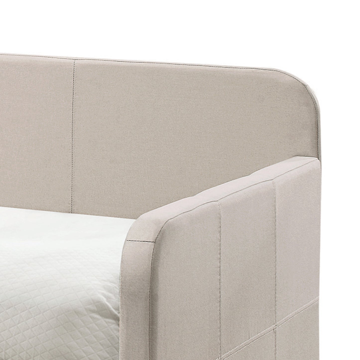 Upholstered beige headboard with detailed stitching on a bed