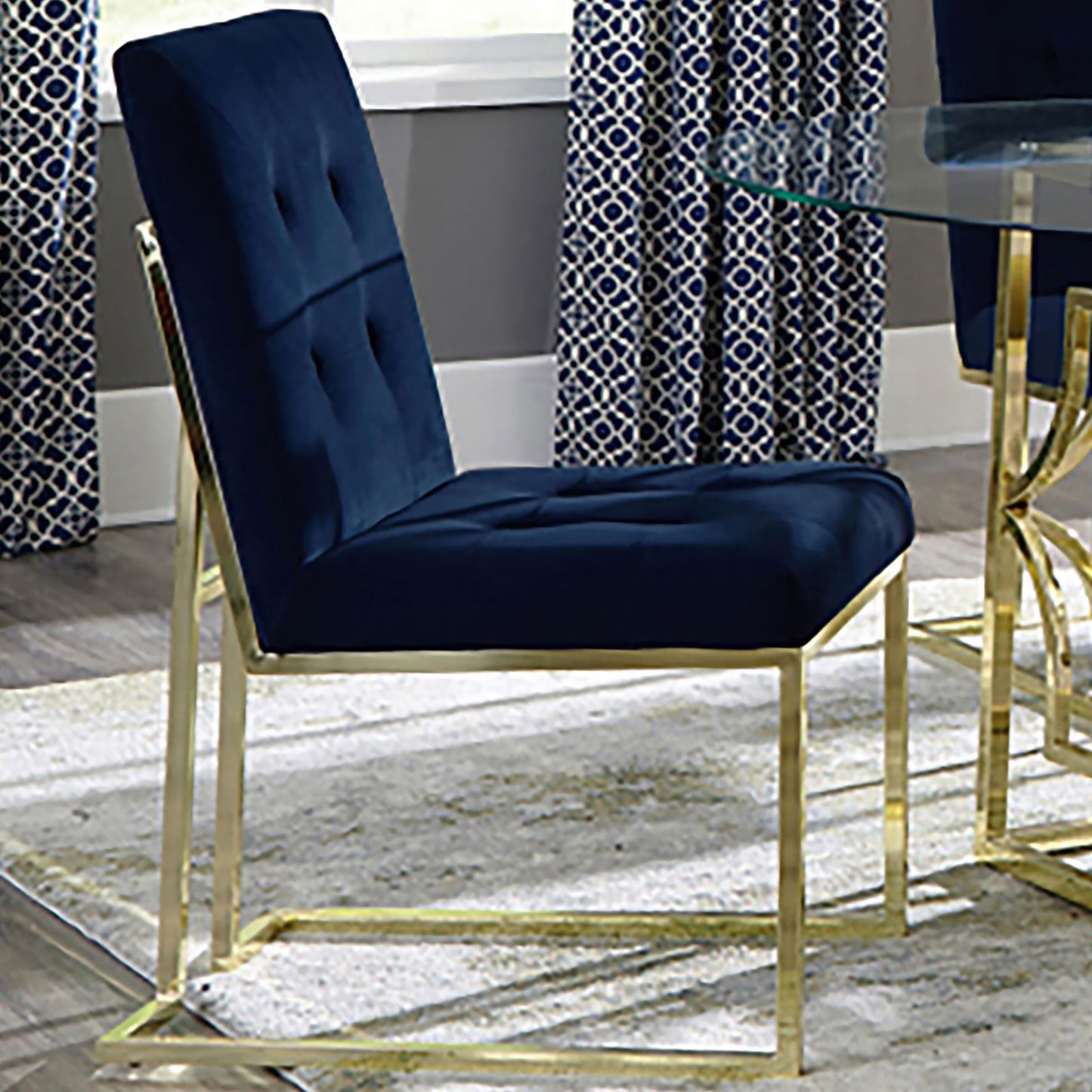 Navy blue velvet dining chair with gold metal legs and diamond tufting