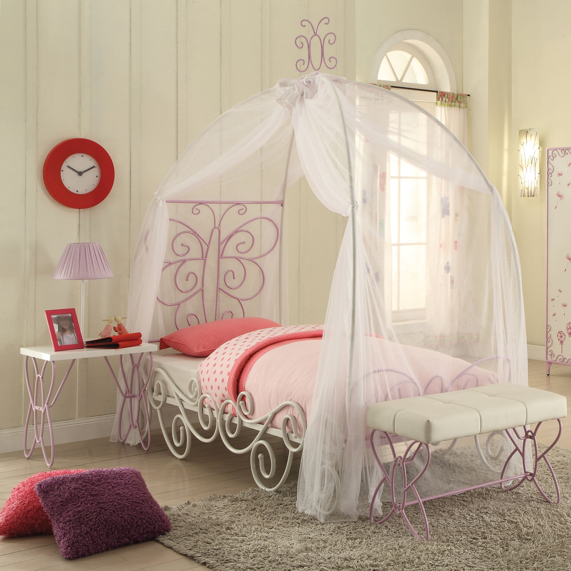 Childrens white metal bed frame with pink butterfly accents and canopy