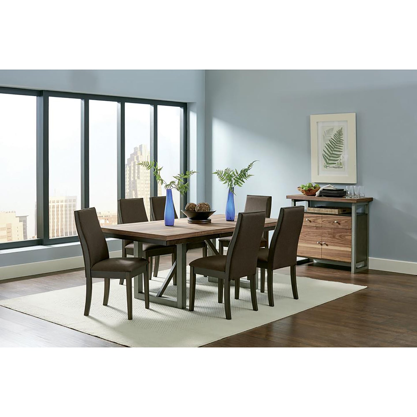 Modern rectangular dining table with dark wood top and metal base seating six upholstered chairs