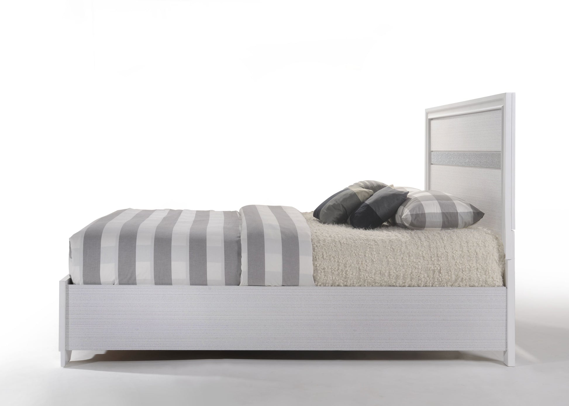 White platform bed frame with textured headboard and grey striped bedding