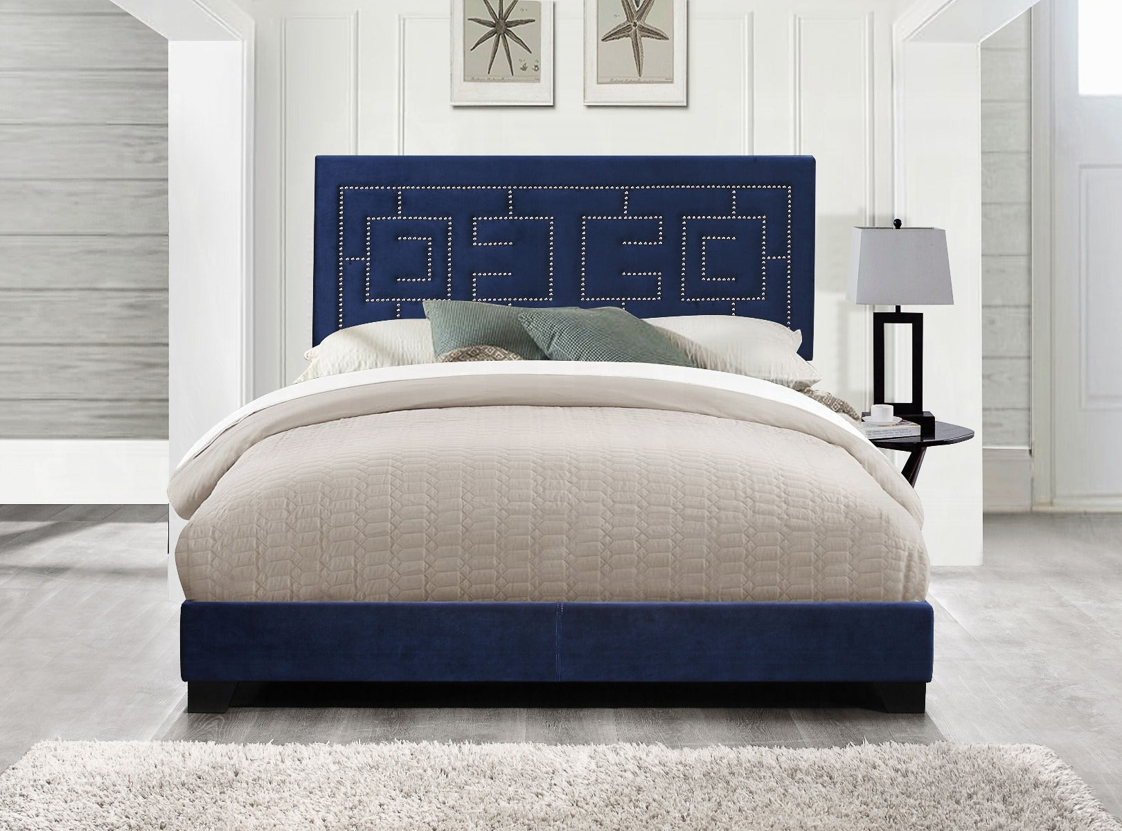 Navy blue velvet bed frame with upholstered geometric headboard and silver nailhead trim