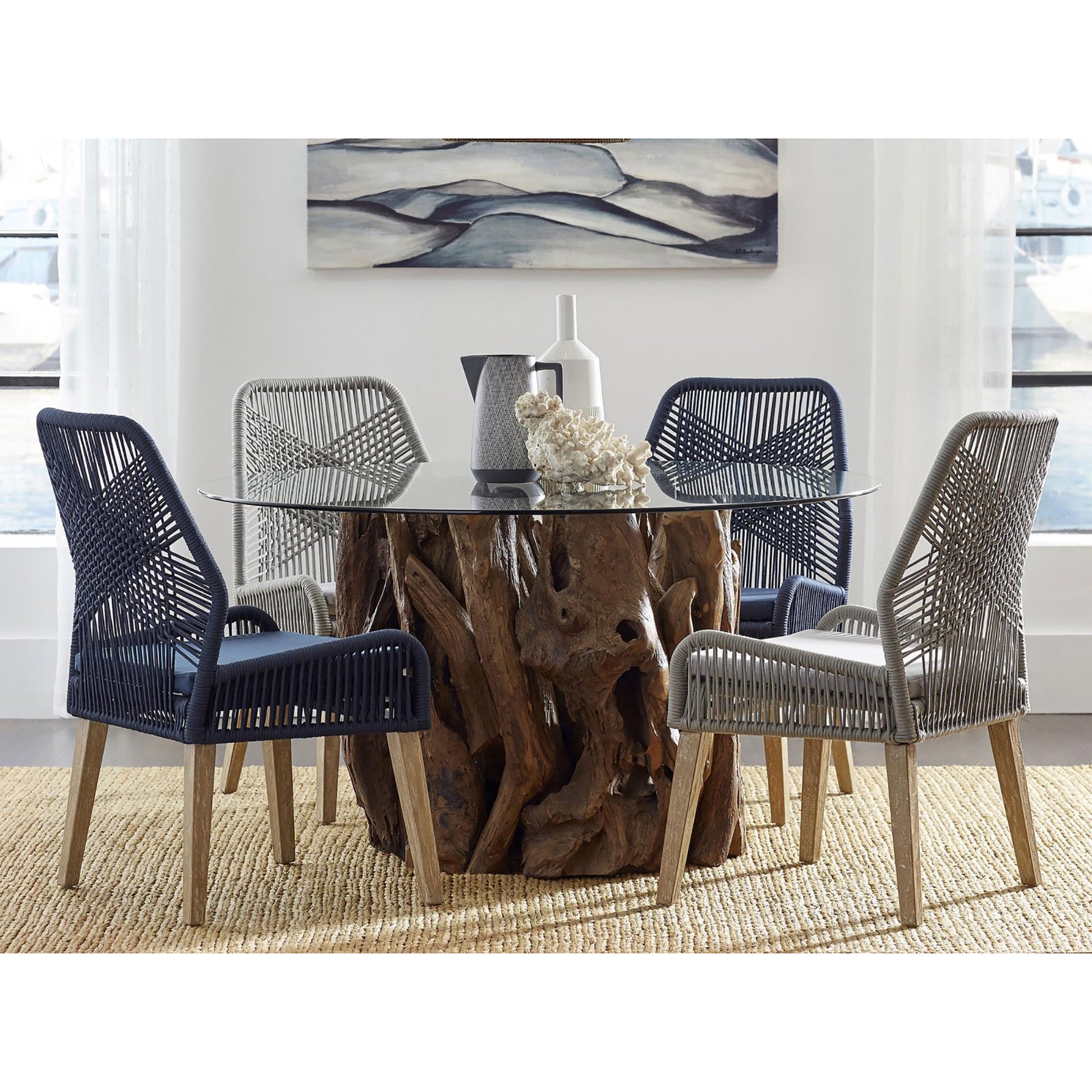 Dark blue ropewoven dining chairs with wood legs and cushions