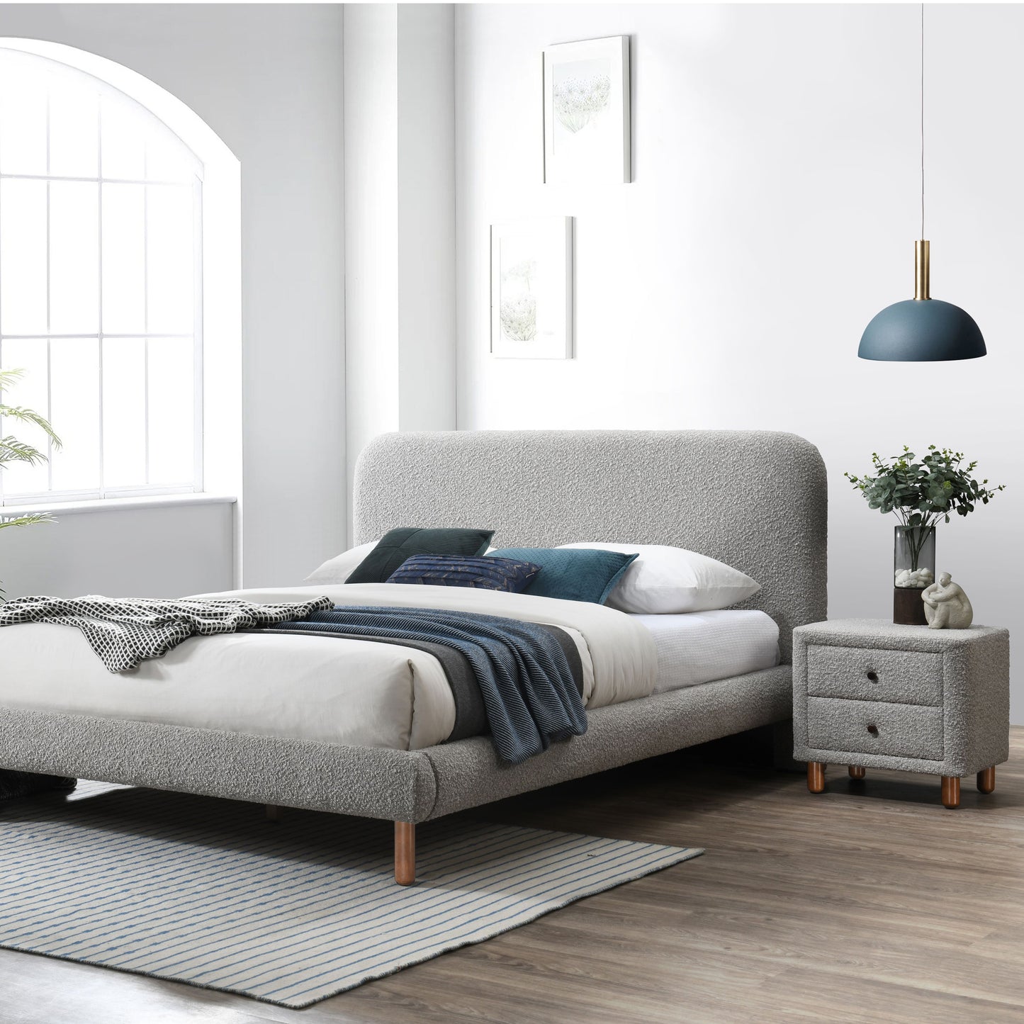 Grey boucle upholstered bed frame with modern design featuring wooden legs