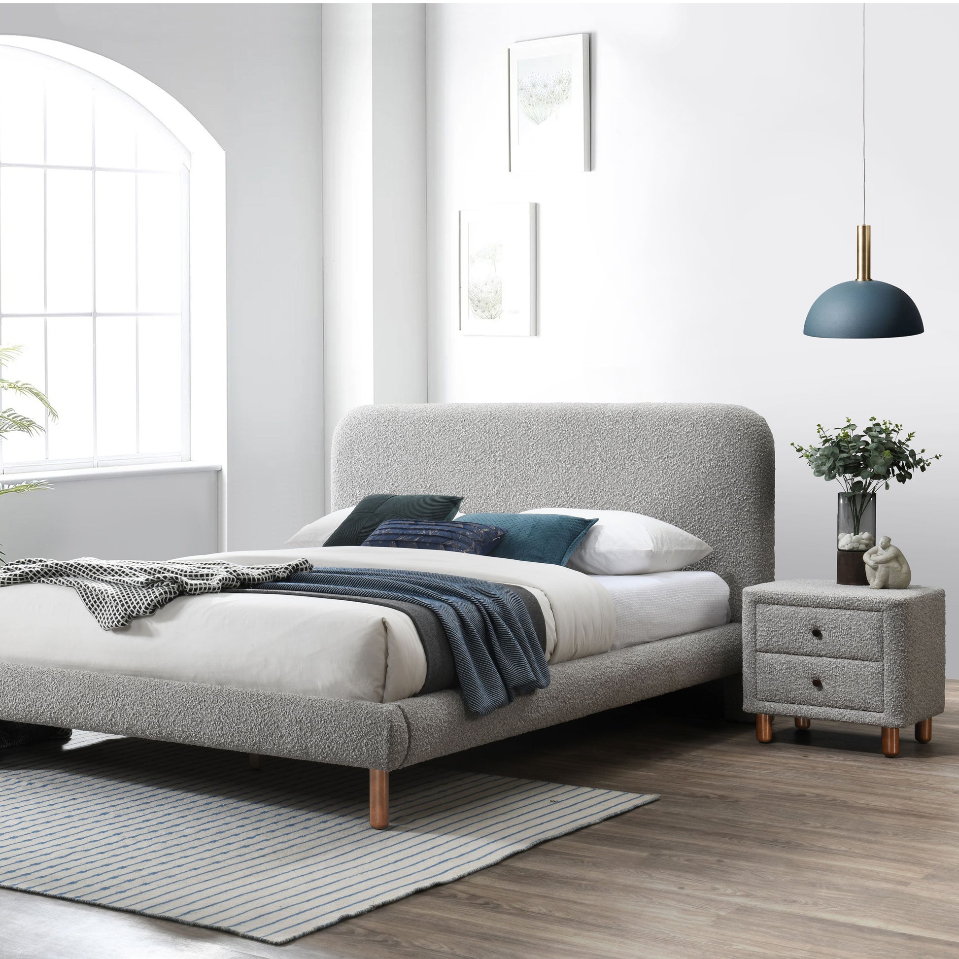 Grey boucle upholstered bed frame with modern design featuring wooden legs