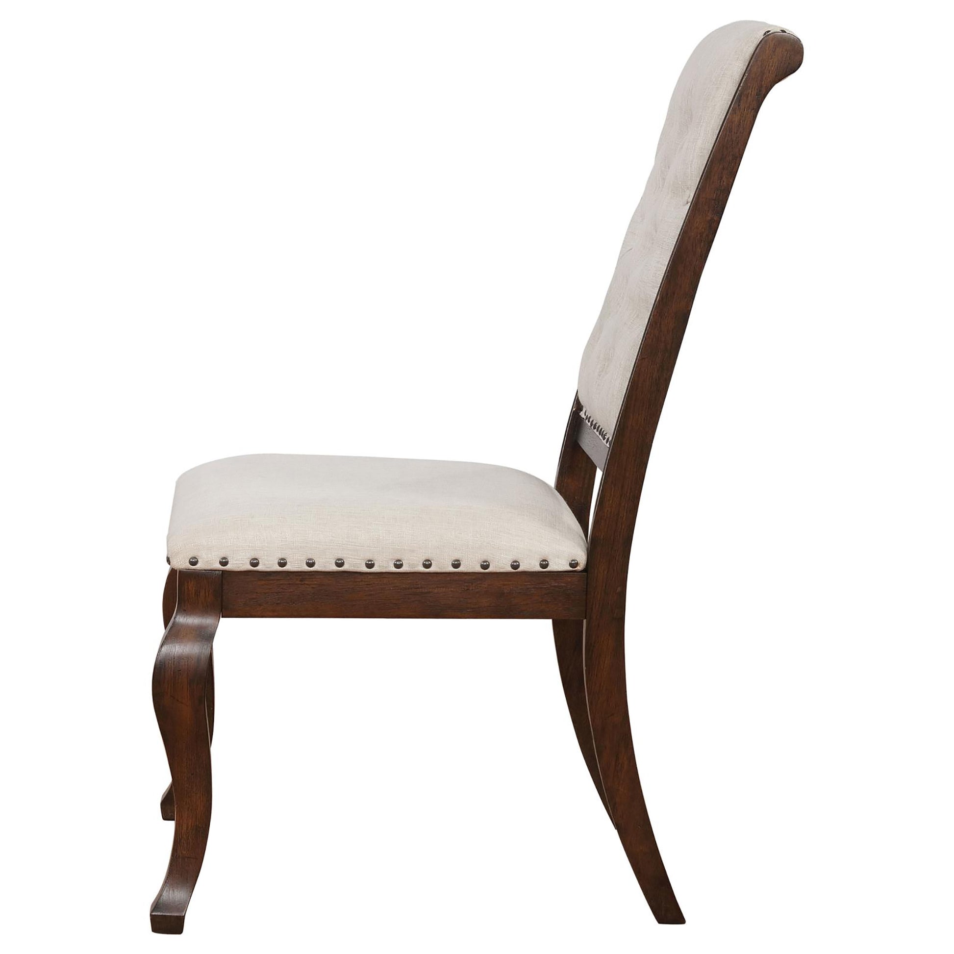 Side view of a wooden dining chair with upholstered cream fabric seat and back