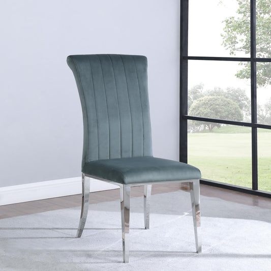 Plush teal velvet dining chair with channel tufting and polished chrome legs