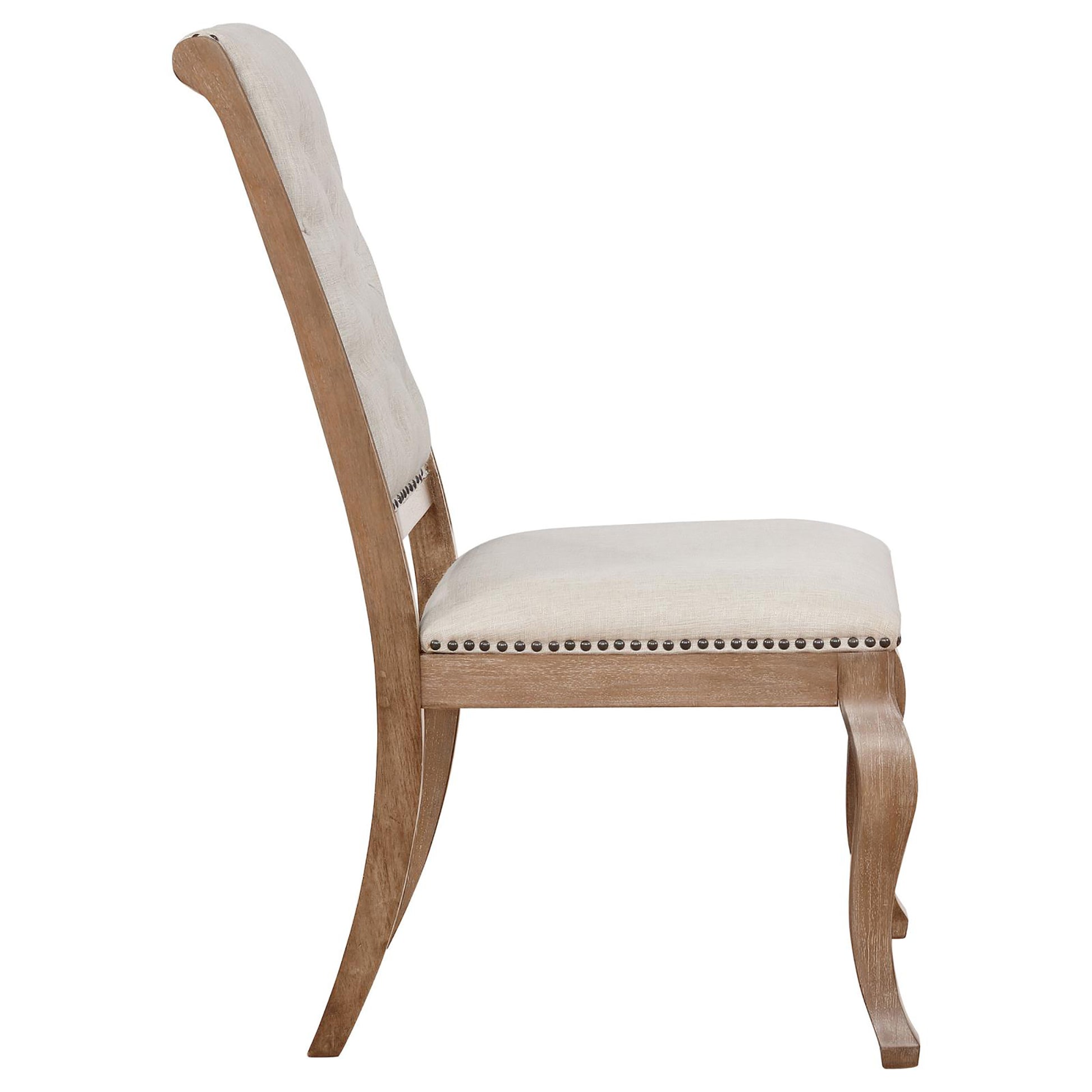 Light beige upholstered dining chair with nailhead trim and carved wood legs