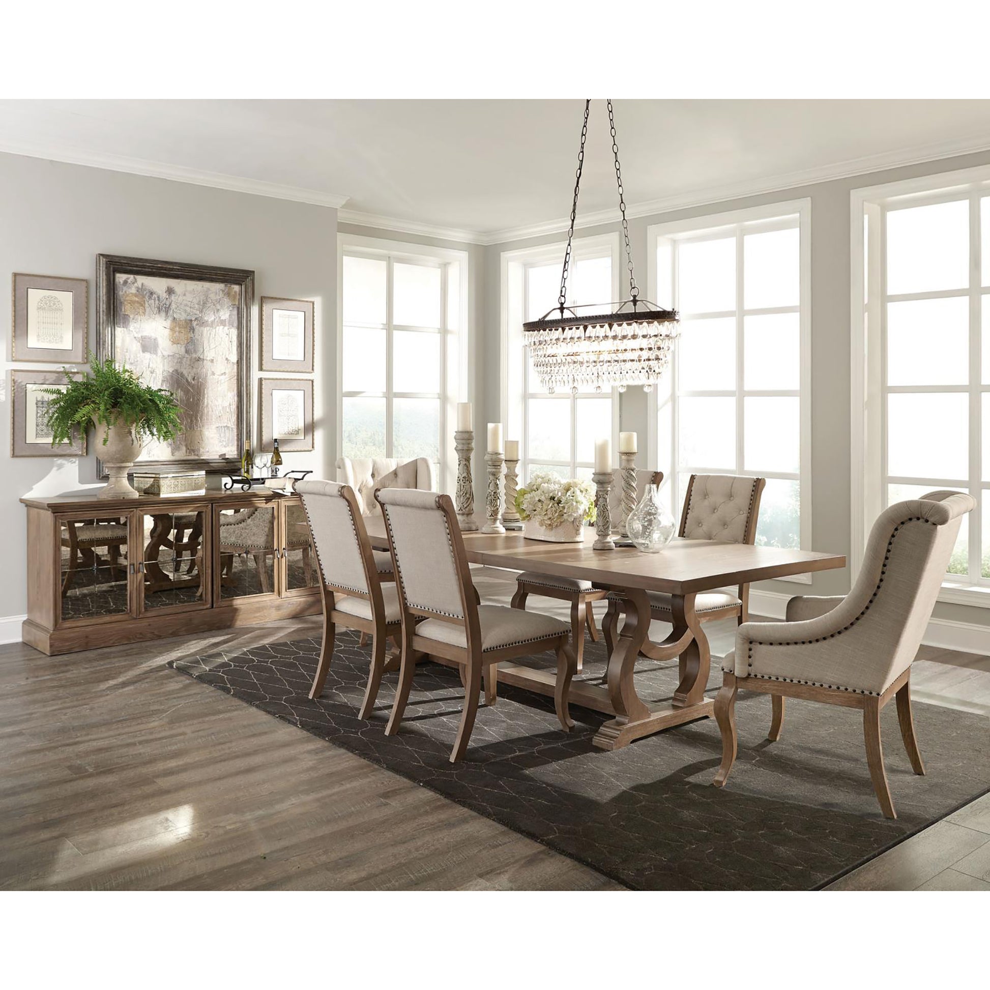 Rustic wood dining table with ornate carved legs and tufted cream upholstered chairs