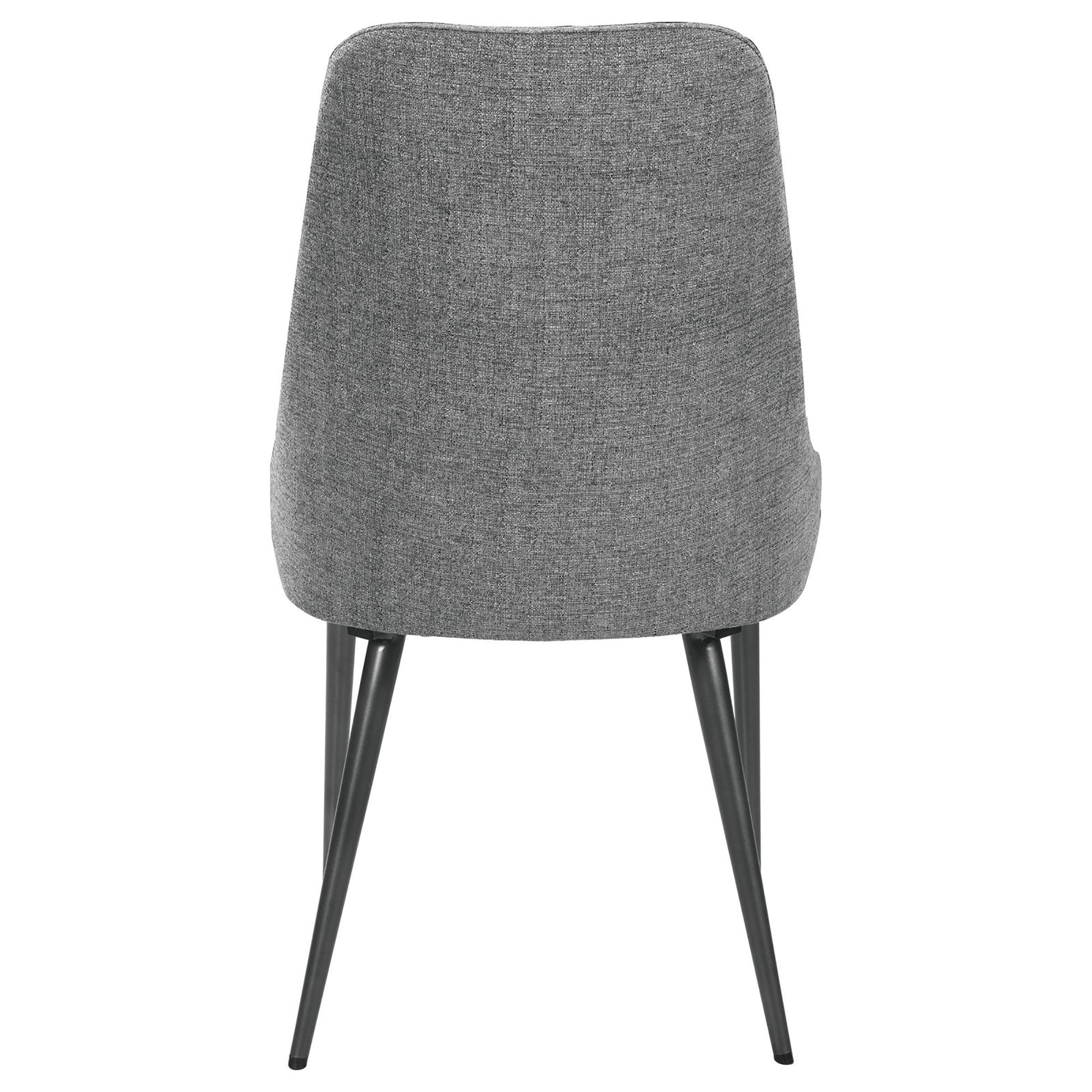 Back view of a grey fabric upholstered dining chair with tapered metal legs