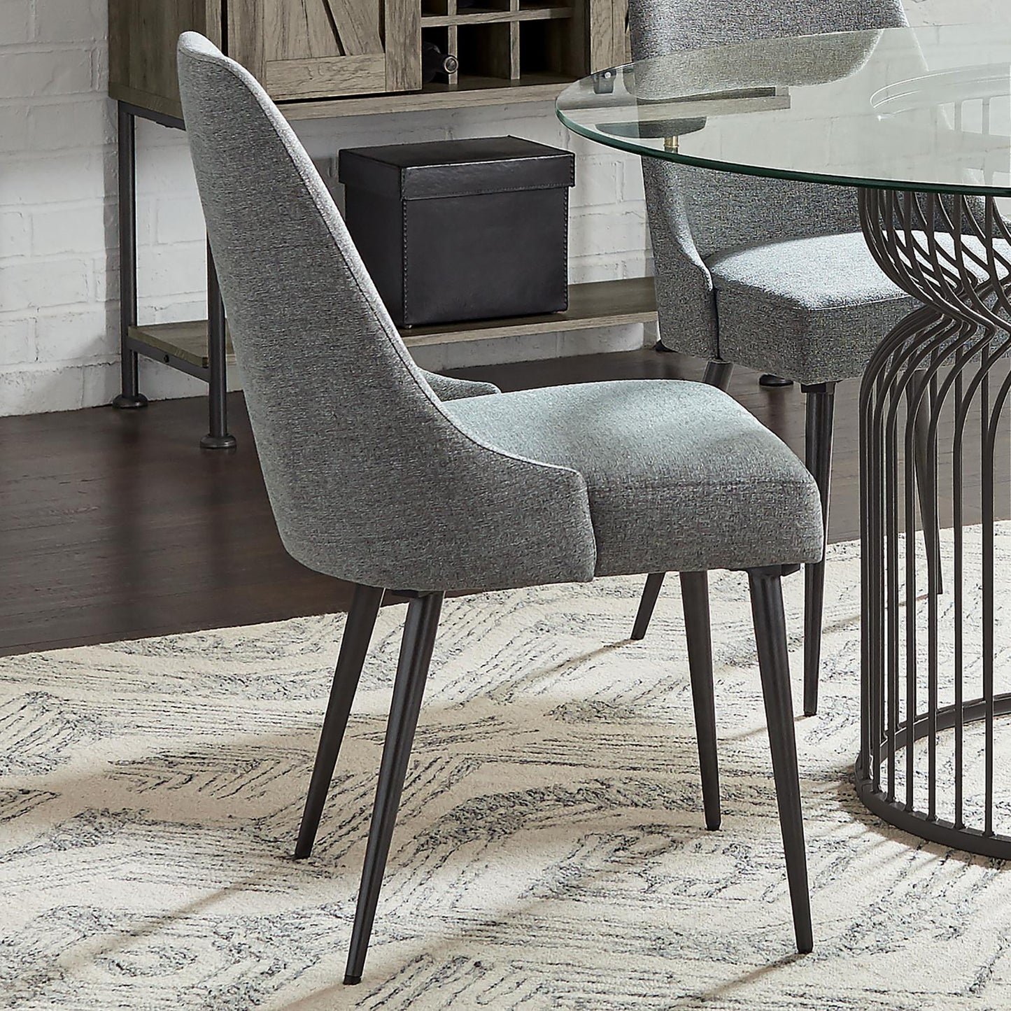 Modern grey upholstered dining chair with dark metal legs perfect for contemporary dining rooms