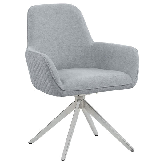 Modern grey fabric armchair with quilted sides and a sleek silver swivel base