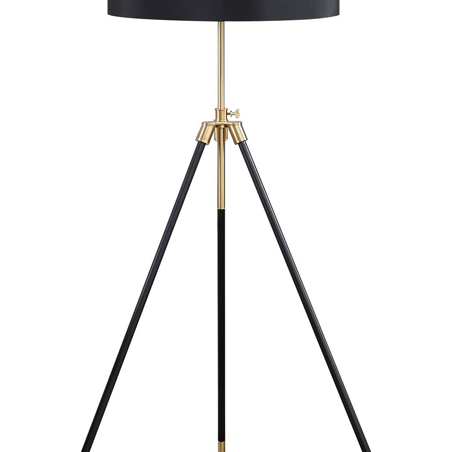 Black tripod floor lamp with brass accents and a minimalist design