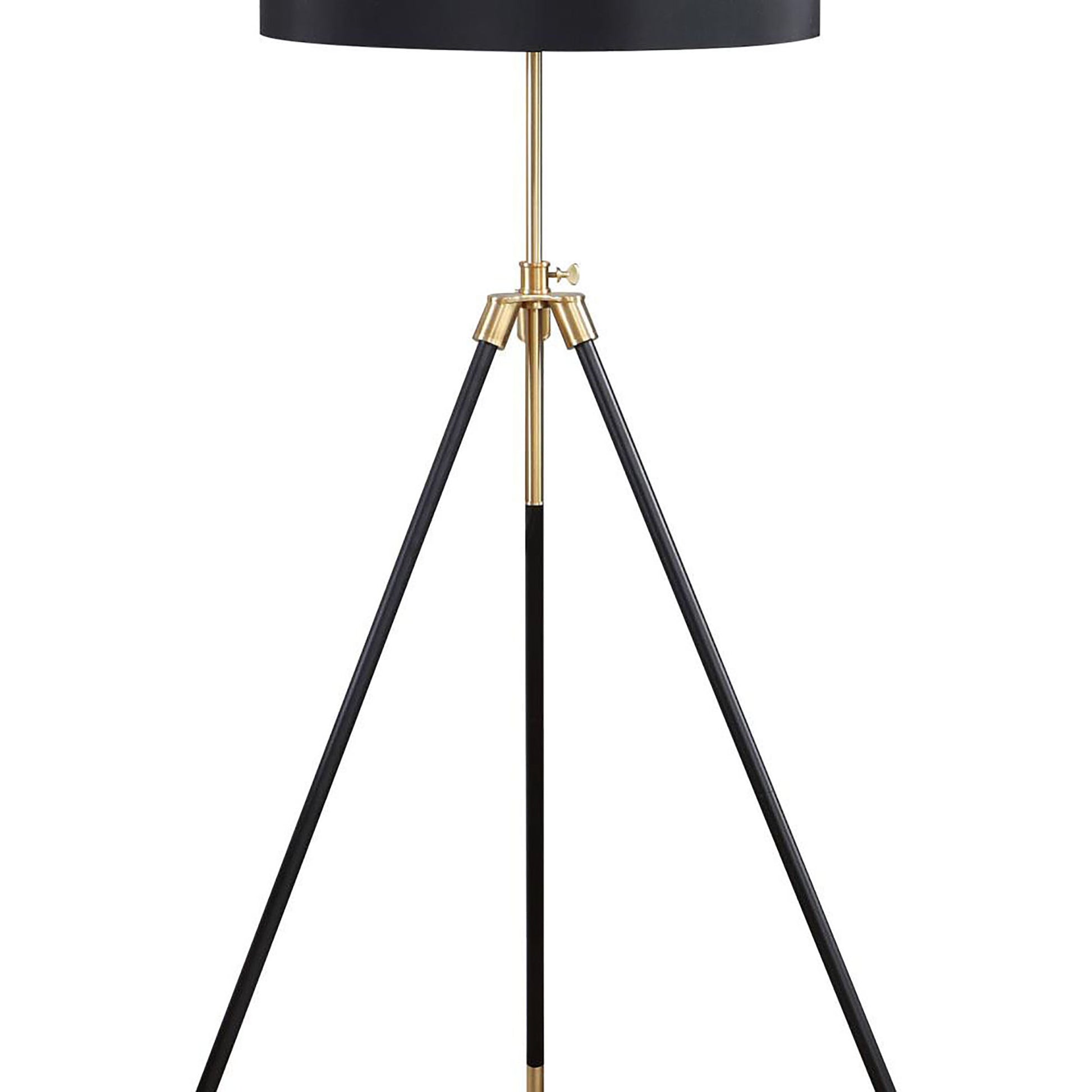 Black tripod floor lamp with brass accents and a minimalist design