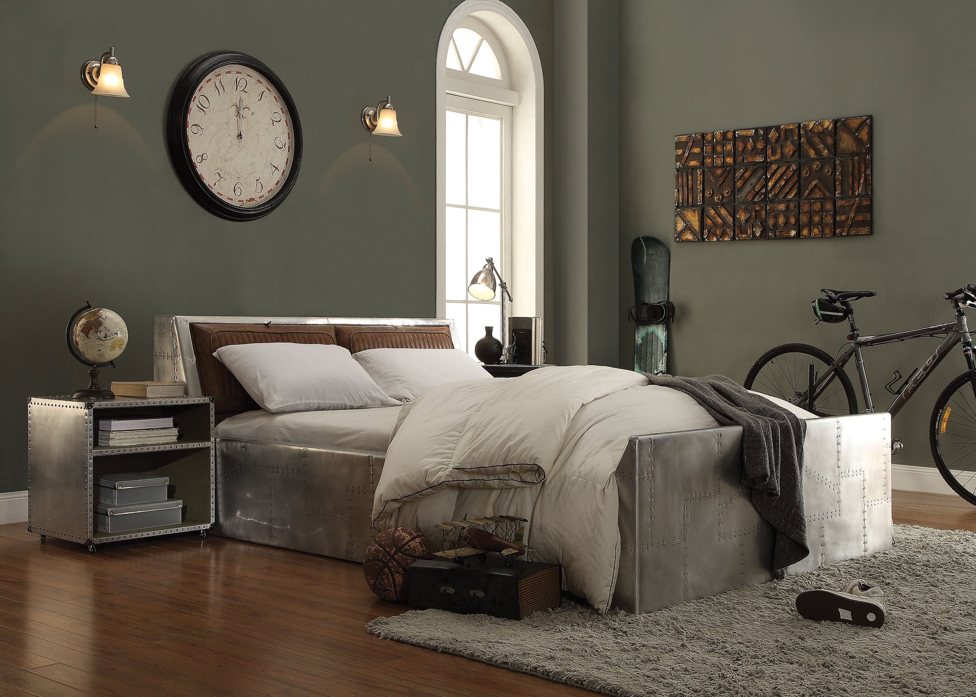 Industrial style platform bed with riveted metal frame and leather headboard complete with bedding