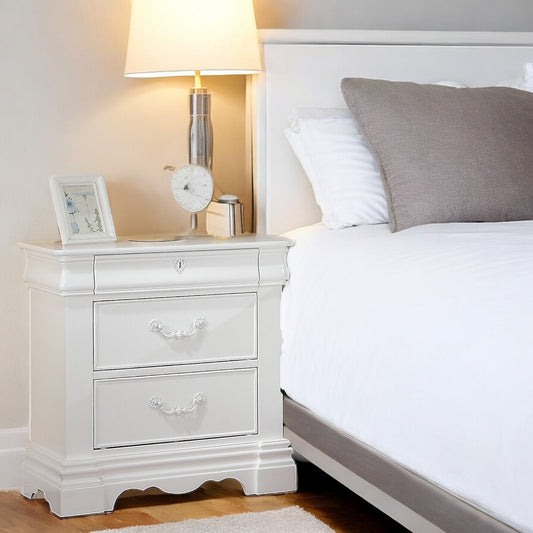 Classic white twodrawer nightstand with ornate metal pulls and ornate drawer fronts