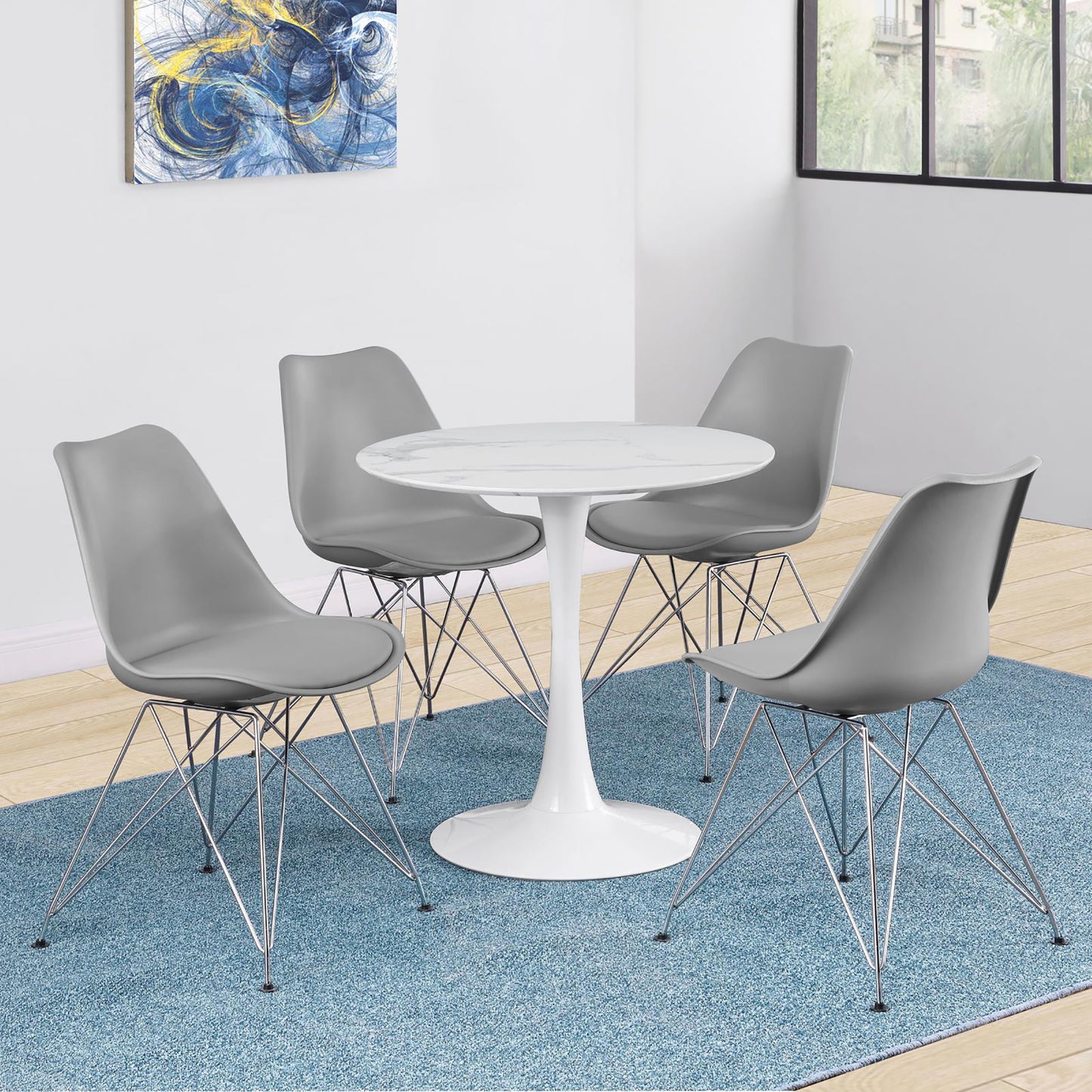 Gray molded dining chairs with chrome legs surround a white marble tulip table