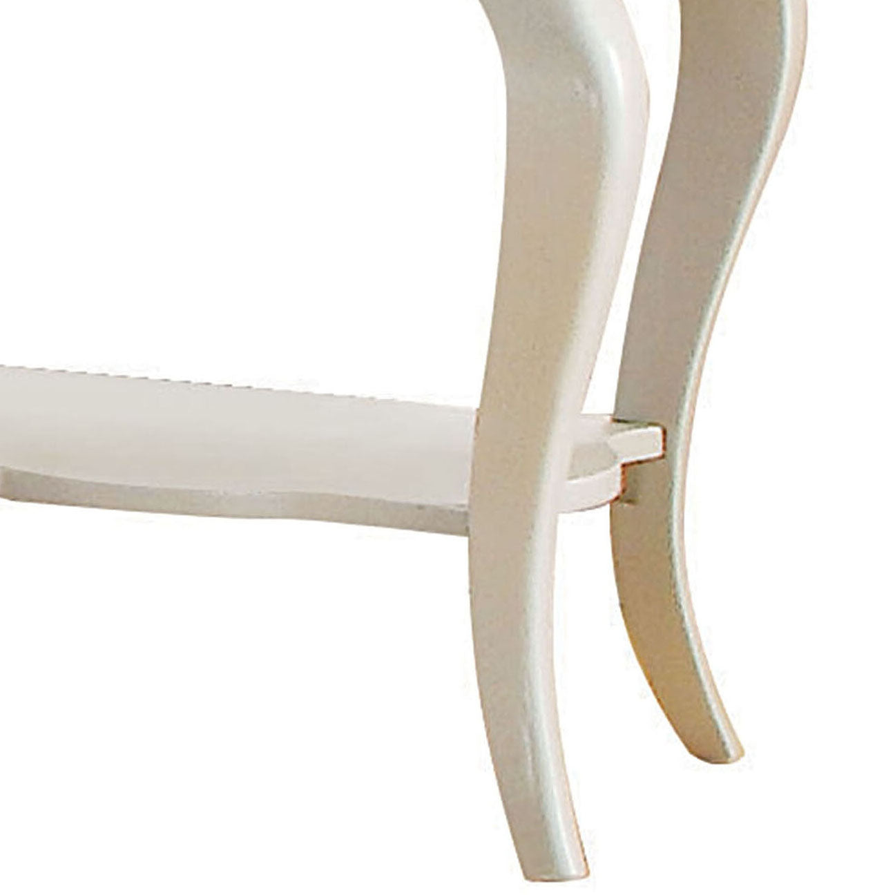 Closeup of ornate white wooden chair leg with curved design