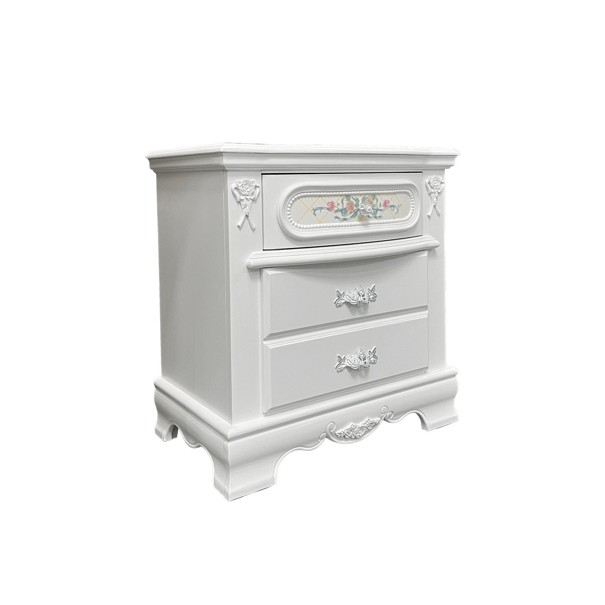 Ornate white wooden nightstand with floral drawer fronts and decorative trim
