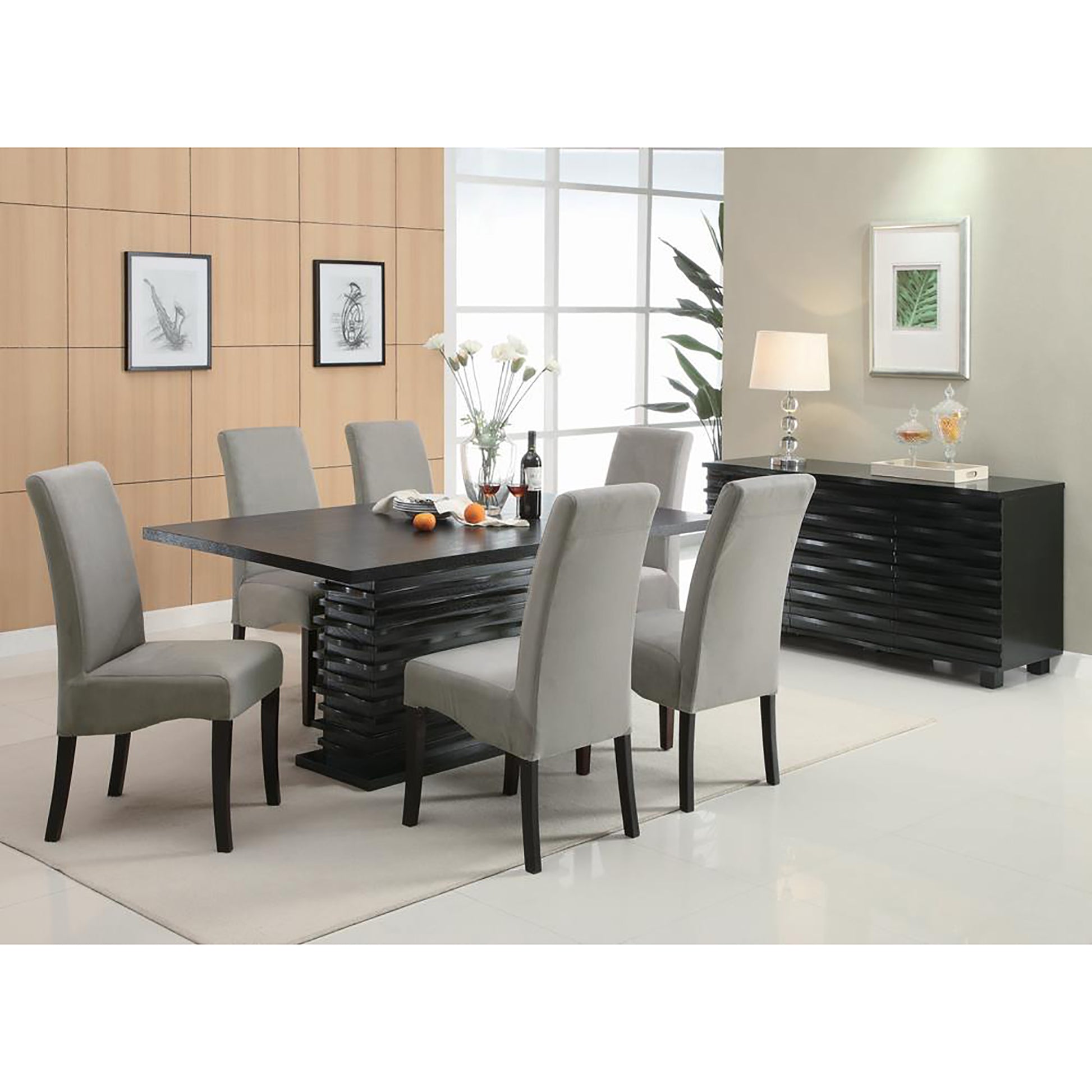 Gray upholstered dining chairs arranged around a black wooden table with a modern design