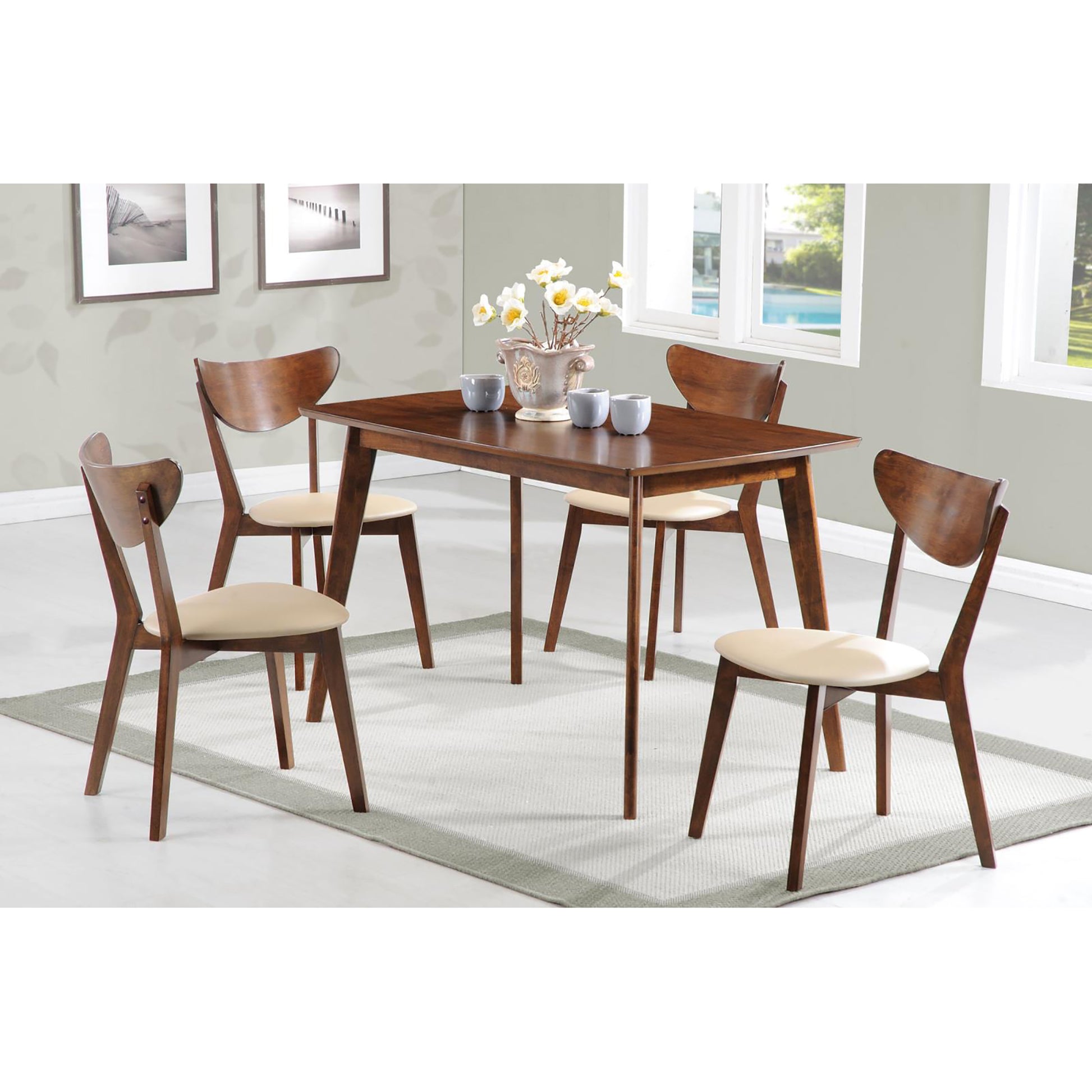 Midcentury modern walnut dining table with four chairs and cream upholstered seats