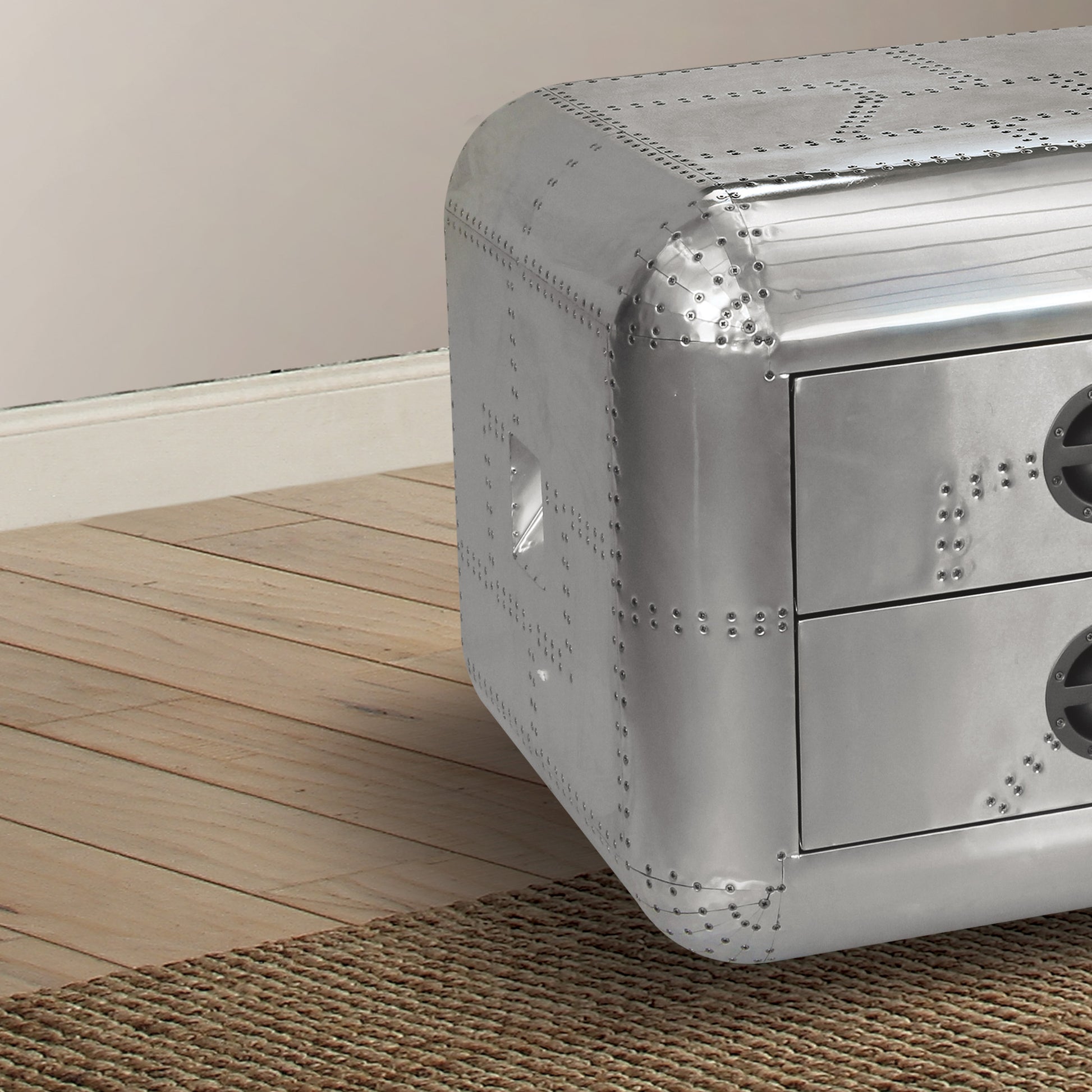 Riveted aluminum bedside table with two drawers and circular accents
