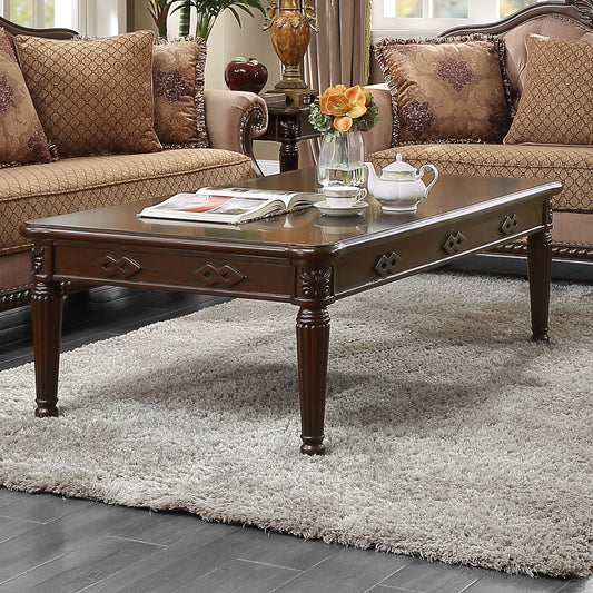 Rich brown hardwood coffee table with ornate carved legs and diamond inlays