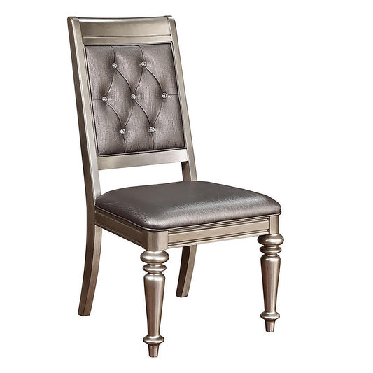 Elegant upholstered dining chair with tufted silver fabric and decorative crystal accents